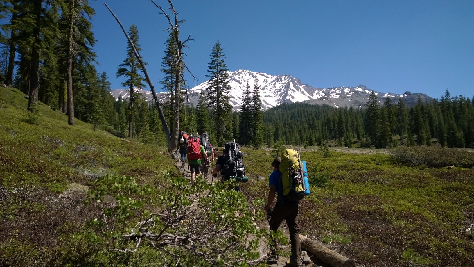 Climbing Mount Shasta Guide Ryan treats a hot spot in the first mile. You don't want a blister on the first day.
