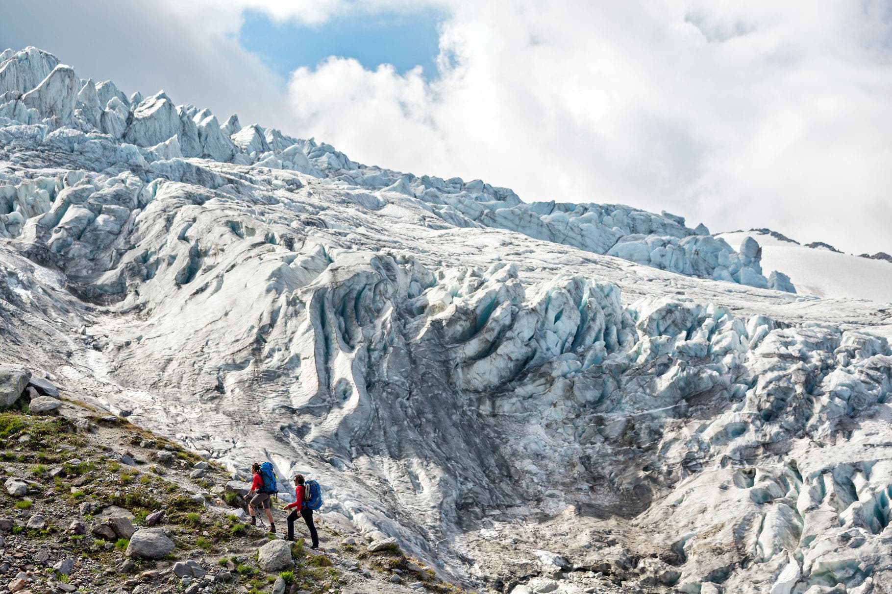 Glacier du Tour Two hikers walking alongside the Glacier du Tour on the first day of the Chamonix to Zermatt Glacier Haute Route.