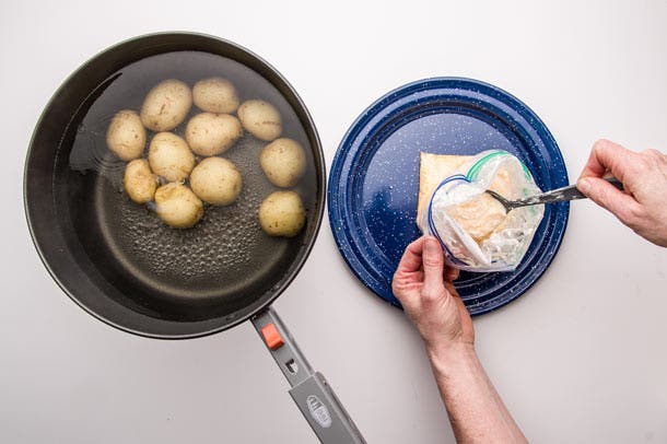 Remove bag from potatoes, stir.