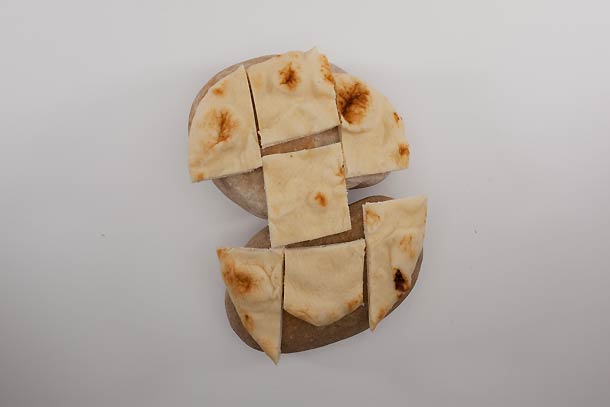 Trail Tapas: Step 4 (optional) Pro move: Warm bread on a hot stone from your campfire. Cut into wedges