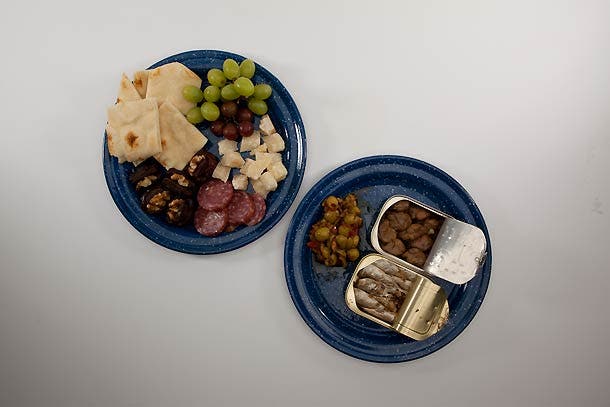 Trail Tapas: Step 8 Arrange grapes, dates, cheese, sausage, and bread on a plate. Place drained can of sardines and tapenade packet on a plate. Assemble creatively!