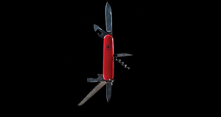 Red swiss army multitool on black background (Ben Fullerton)