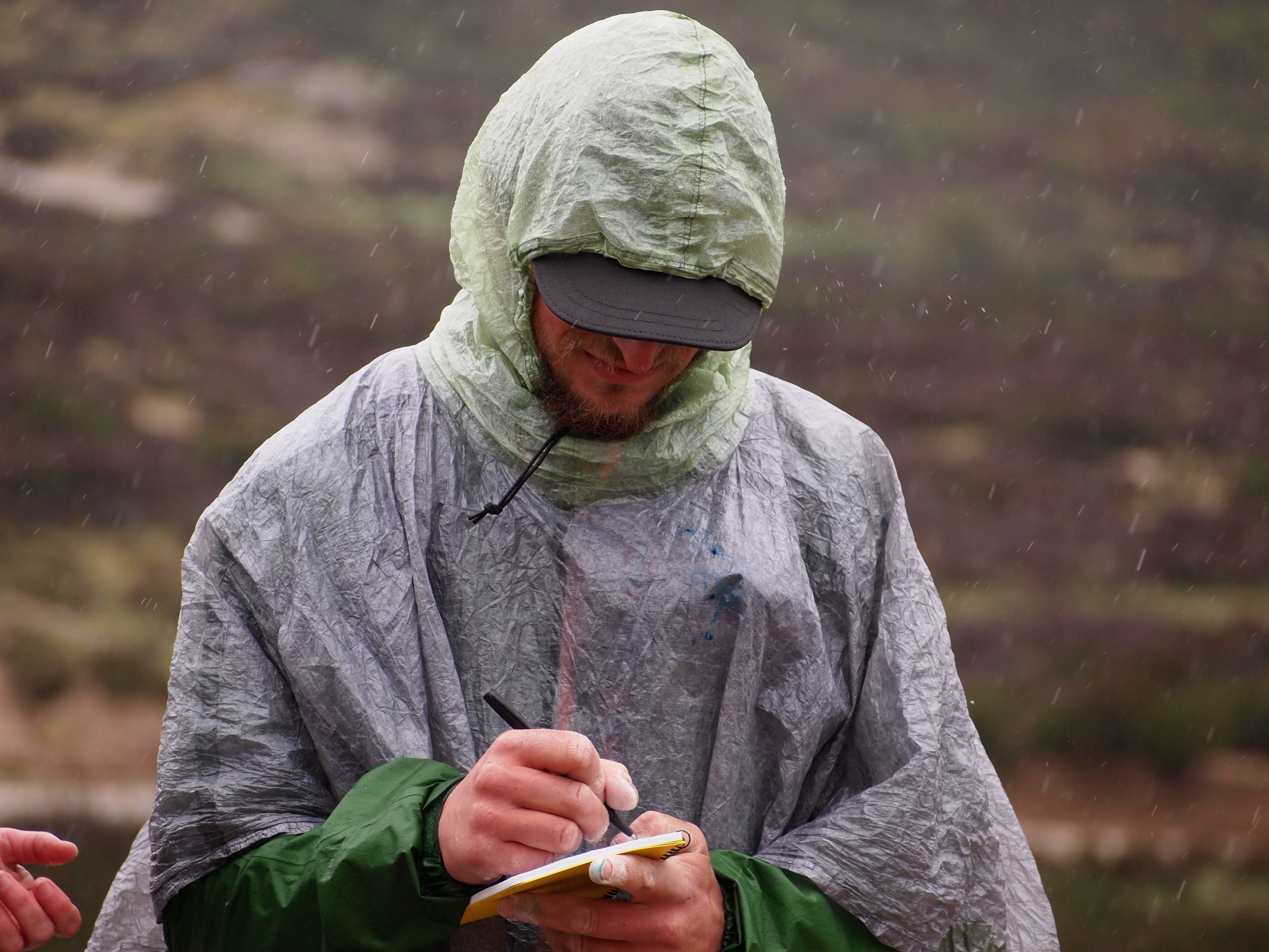 Justin Lichter Lichter signs the register, marking the end of the hike (photo/Pea Hicks)