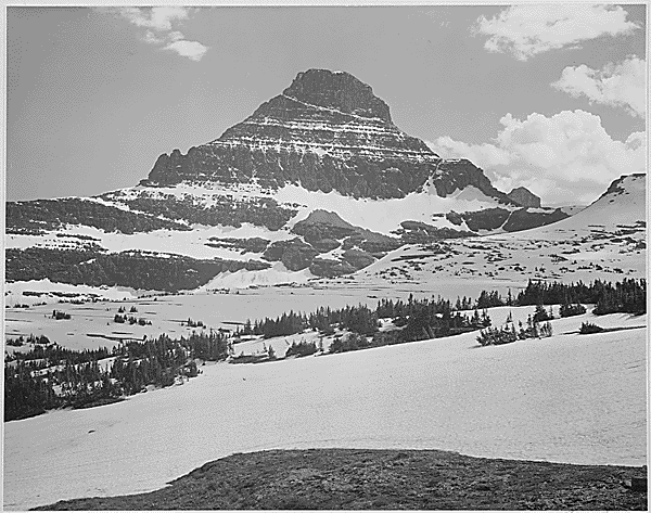 Looking across barren land to mountains, “From Logan Pass, Glacier National Park,” Montana, 1933-1942 photo: Ansel Adams / U.S. Department of the Interior