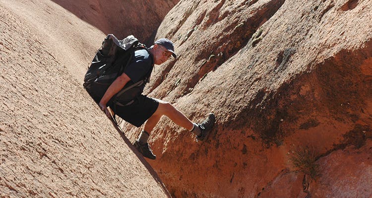 Photo by Greg Child David Roberts hikes the faint old trail past a typical Navajo cairn.