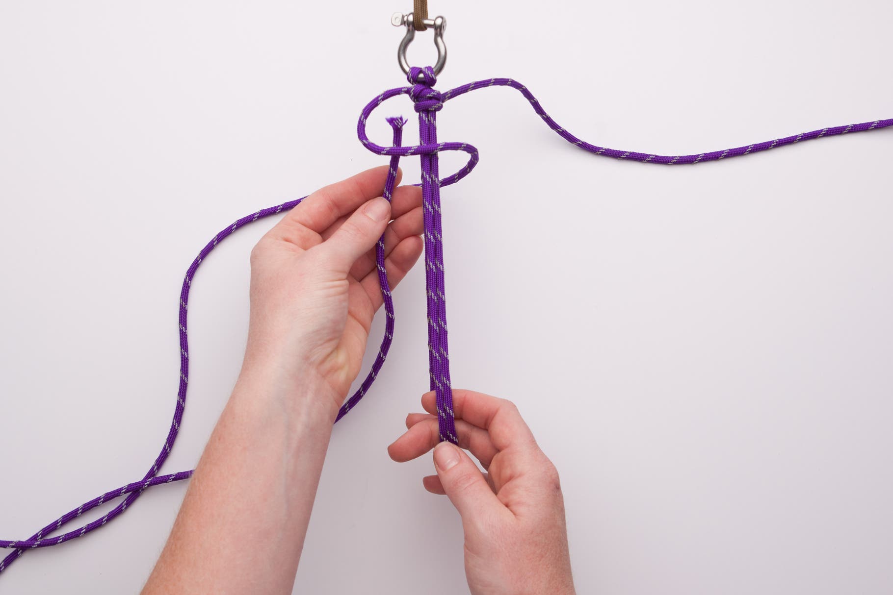 Make a Paracord Survival Bracelet 10 Repeat on the left side, going over the front and up through the loop from the back.