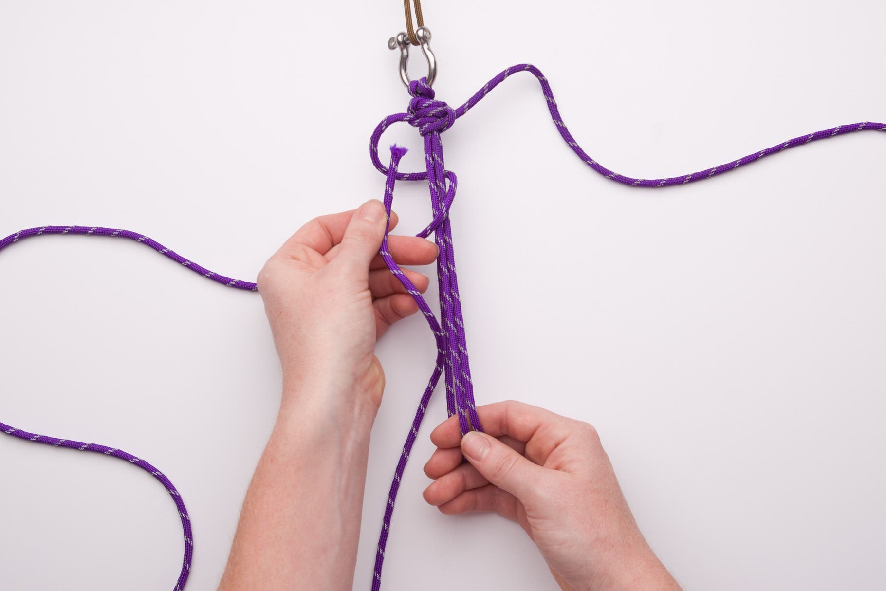 Repeat on the left side, remembering to go behind the middle cords, over the front, and through the loop from front to back. Pull it tight and slide…