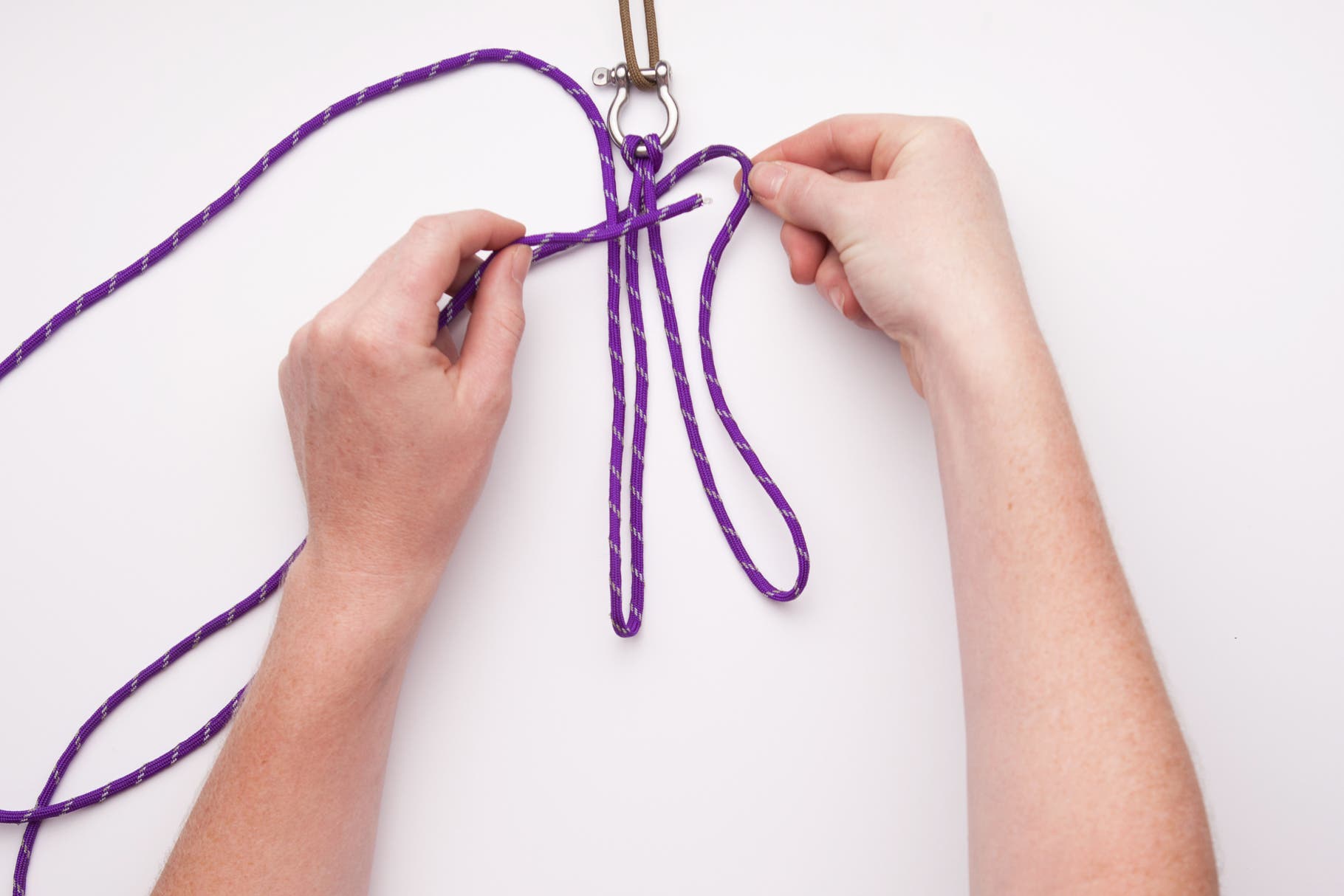The first two knots are the base of the bracelet. Begin by bringing the longer cord from the right and wrapping it behind all of the other cords,…