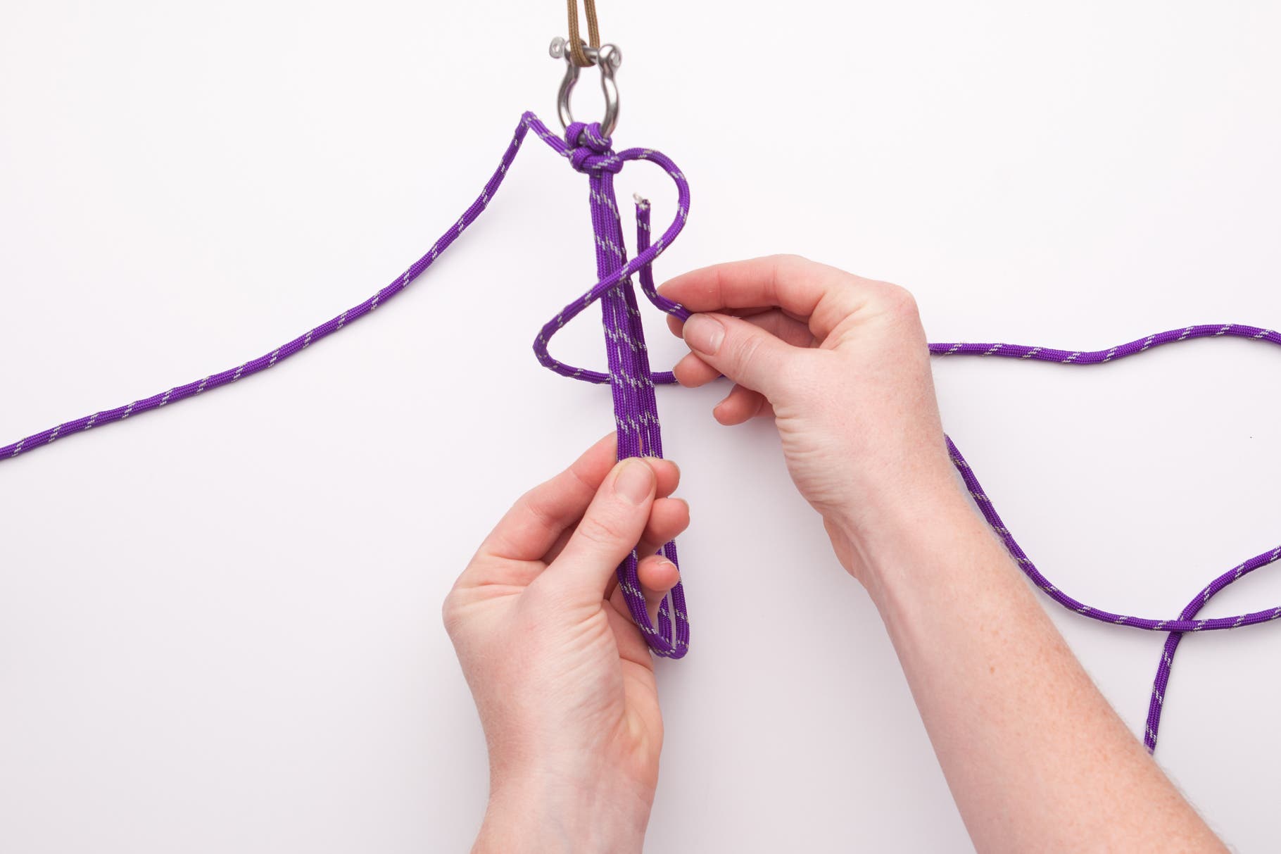 Now that you have a solid base you can begin the repetitive knotting process. Grab the long cord on the right, wrap it in front of the middle cords…