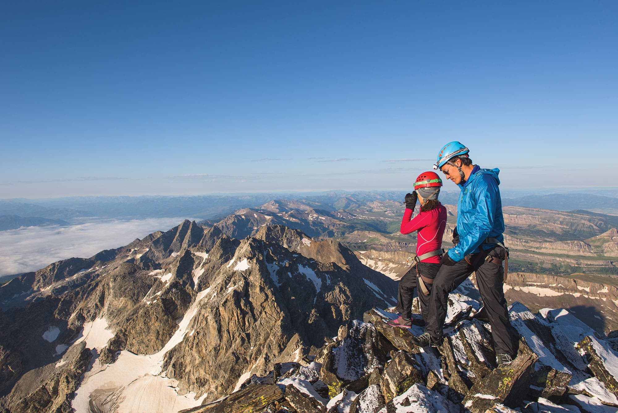 Two climbers enjoy the view from The Enclosure, a sub-summit of Grand Teton.