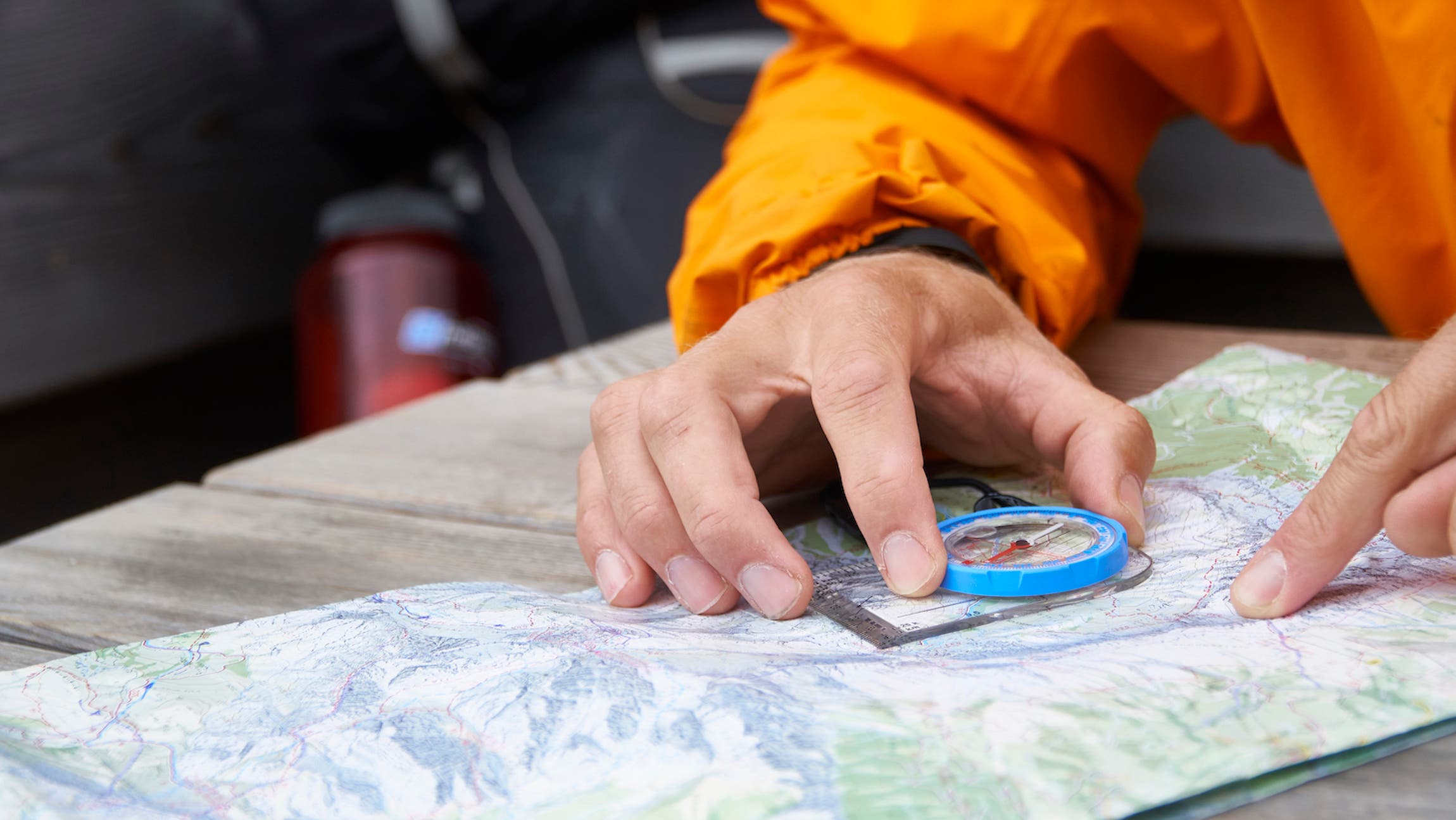 Hiker reading map with compass