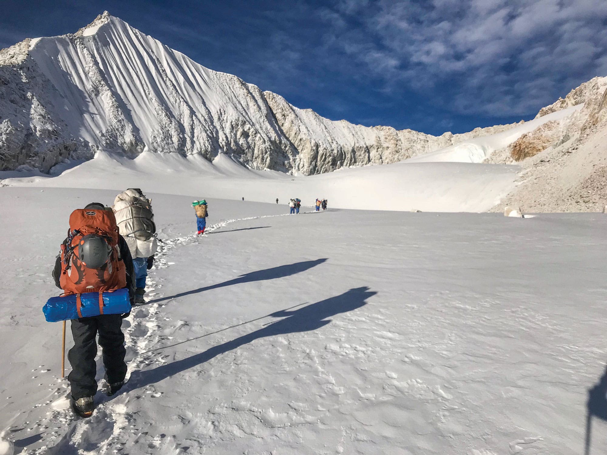 Sherpani Col, Great Himalaya Trail Hikers trek over snow-covered terrain on approach to Sherpani Col on the Great Himalaya Trail.