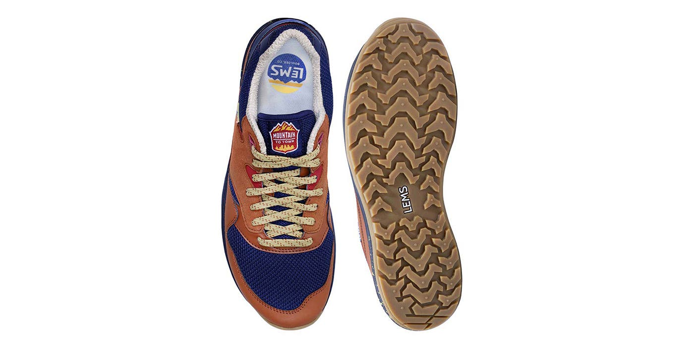 Lems_Trailhead_Backpacker_HGG Brown and blue Lems minimalist hiking shoes sit on a white background.