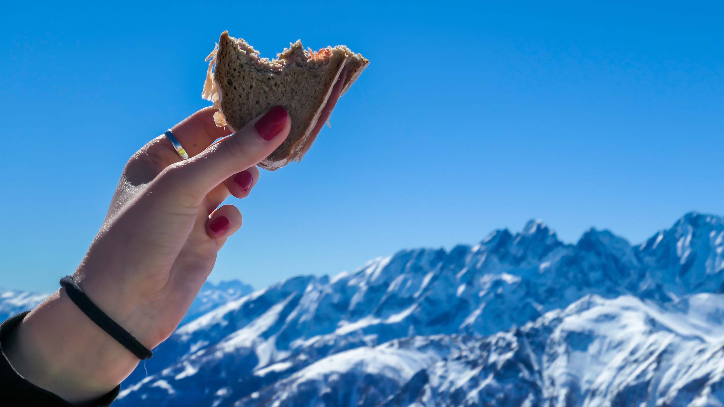 Skier Eating Sandwich