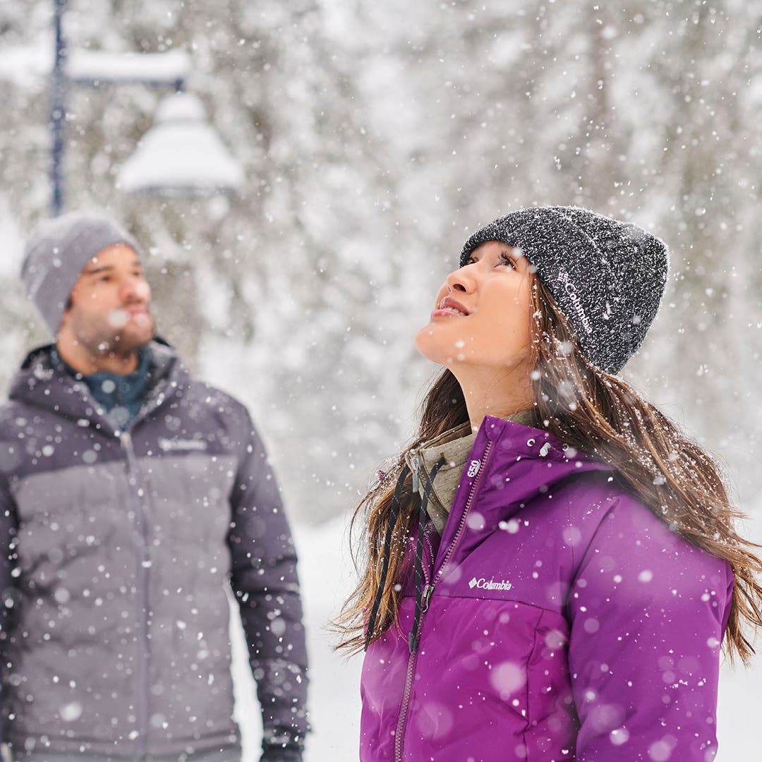 DickssportingGoods Man and women in Columbia jackets watching snow fall.
