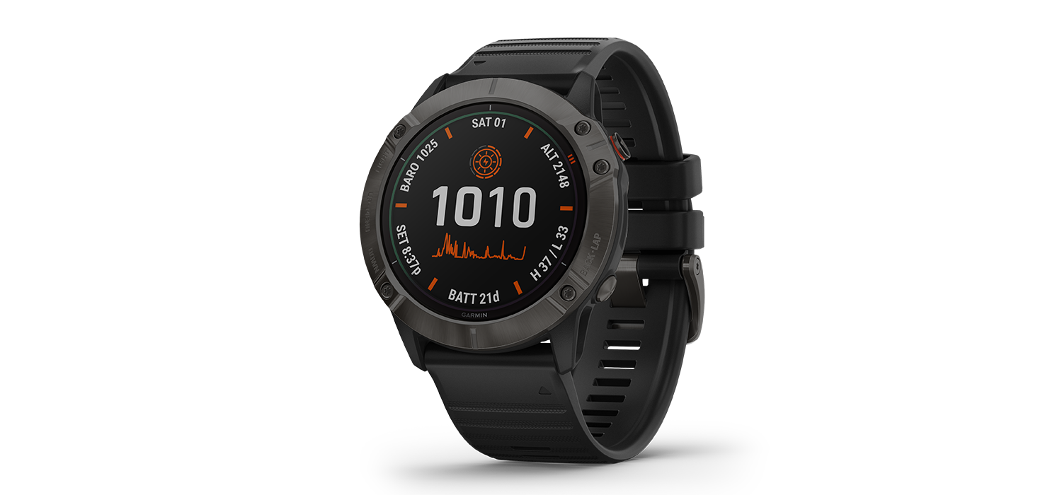 "Garmin fenix 6X Solar Pro watch with a black band sits on a white background. The watchface has a white 1010 above a graph line."