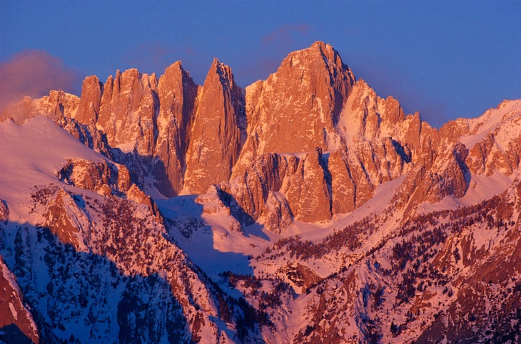 the cliffy face of Mt. Whitney is turned rose-gold by the sunlight