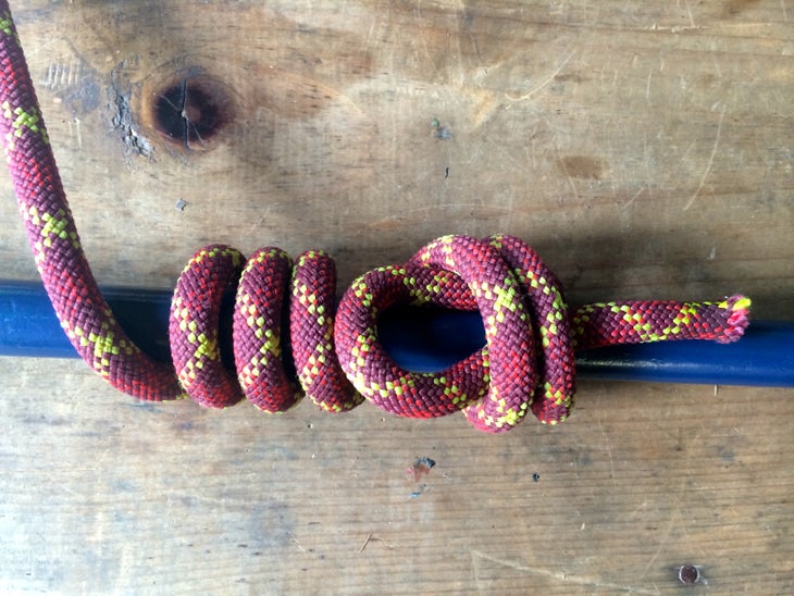backpacker’s hitch knot wrapped around a blue stake