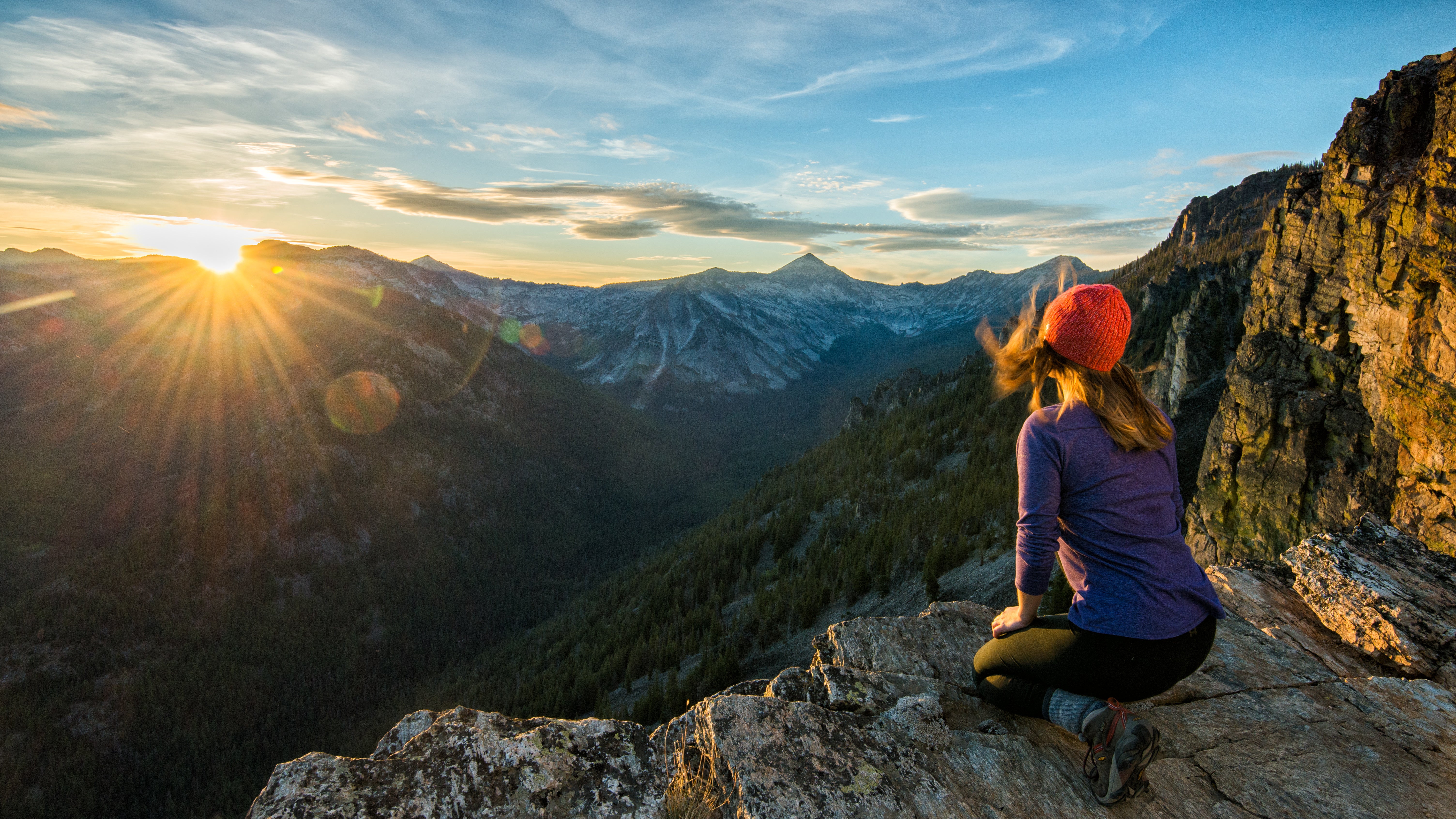 "A hiker watches sunset over the Bitteroots from Bear Creek Overlook in the Selway-Bitterroot Wilderness"