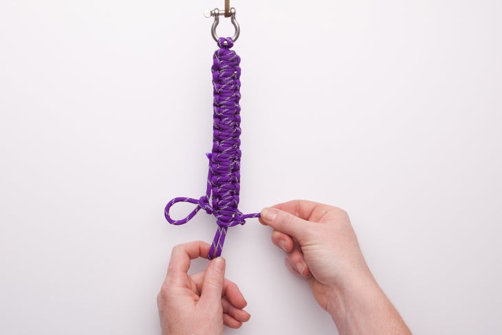 Make a Paracord Survival Bracelet 17 Pull the end string tight. Now, thread those middle loops through the left loop and again tighten the end string.
