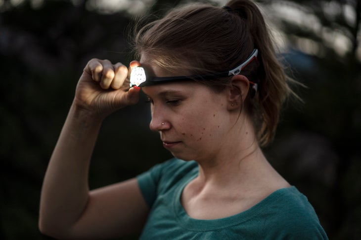 Premium Photo  A head torch light lamp on the person, exploration