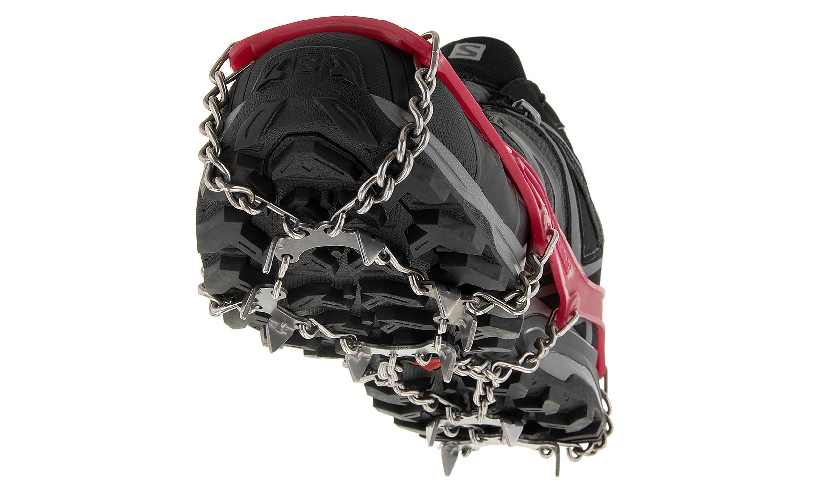Kahtoola red MICROspikes wrap around a black hiking boot. Angle of photo is bottom of the shoe from the front looking up.