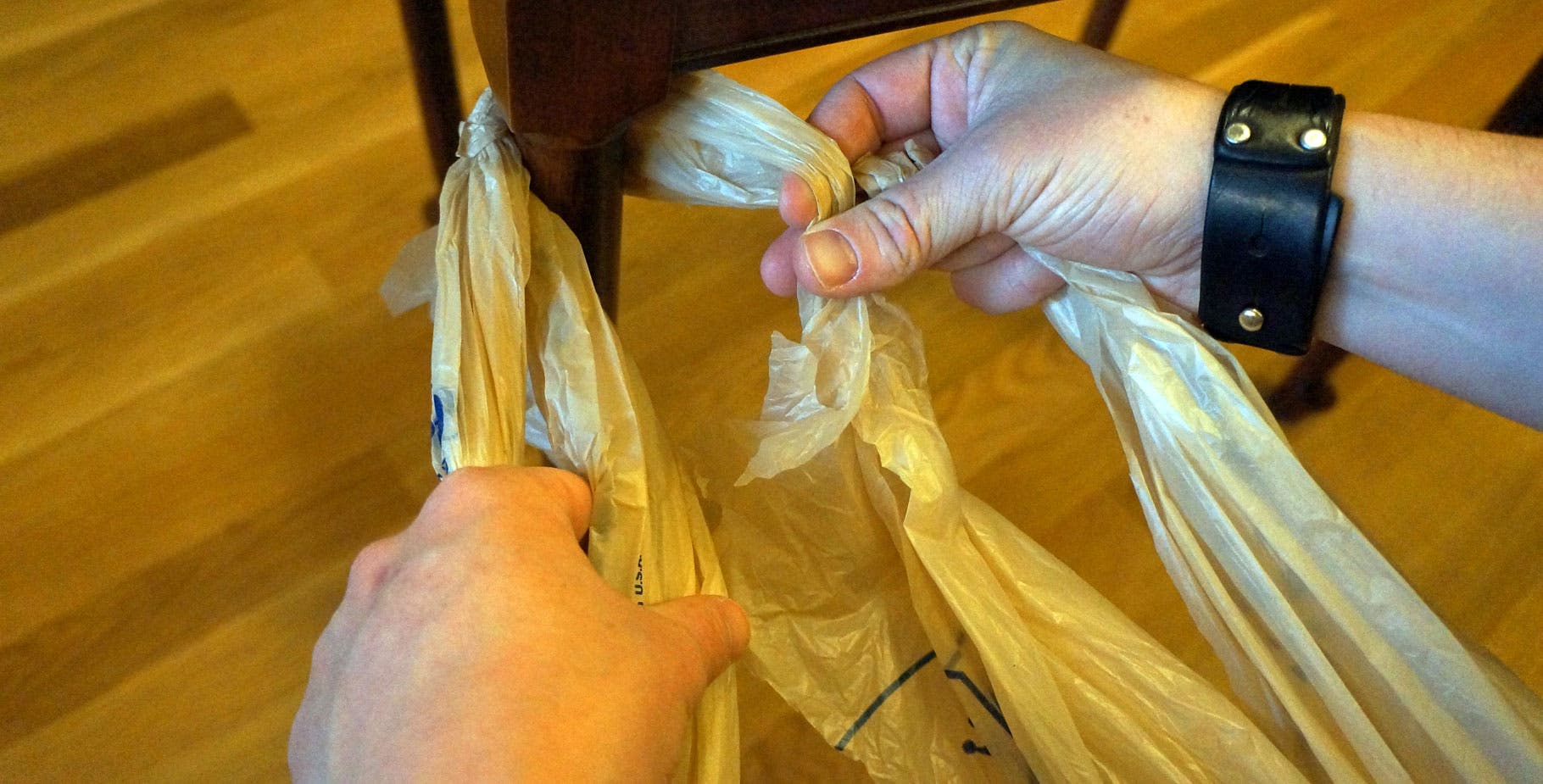Plastic Bags: Step 11 In your right hand, fold the right strand over left.