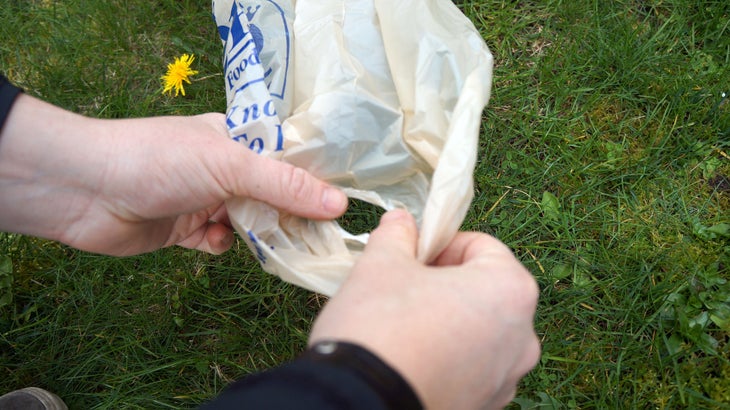 Plastic Bags: Step 4 Now begin connecting half-bags to make strands. Open one and poke a hole near the bottom seam on the side of the half-bag.