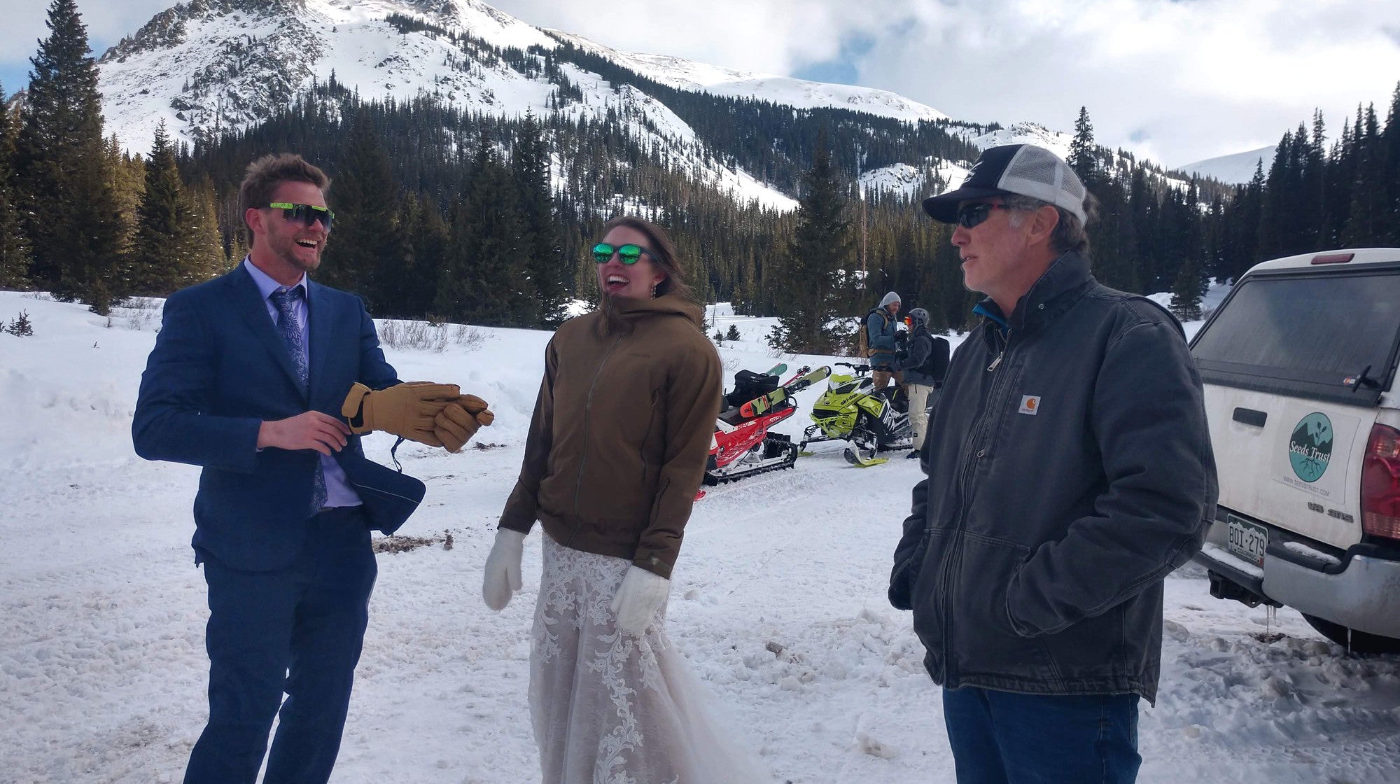 Bride and groom in parking lot with snowmobile