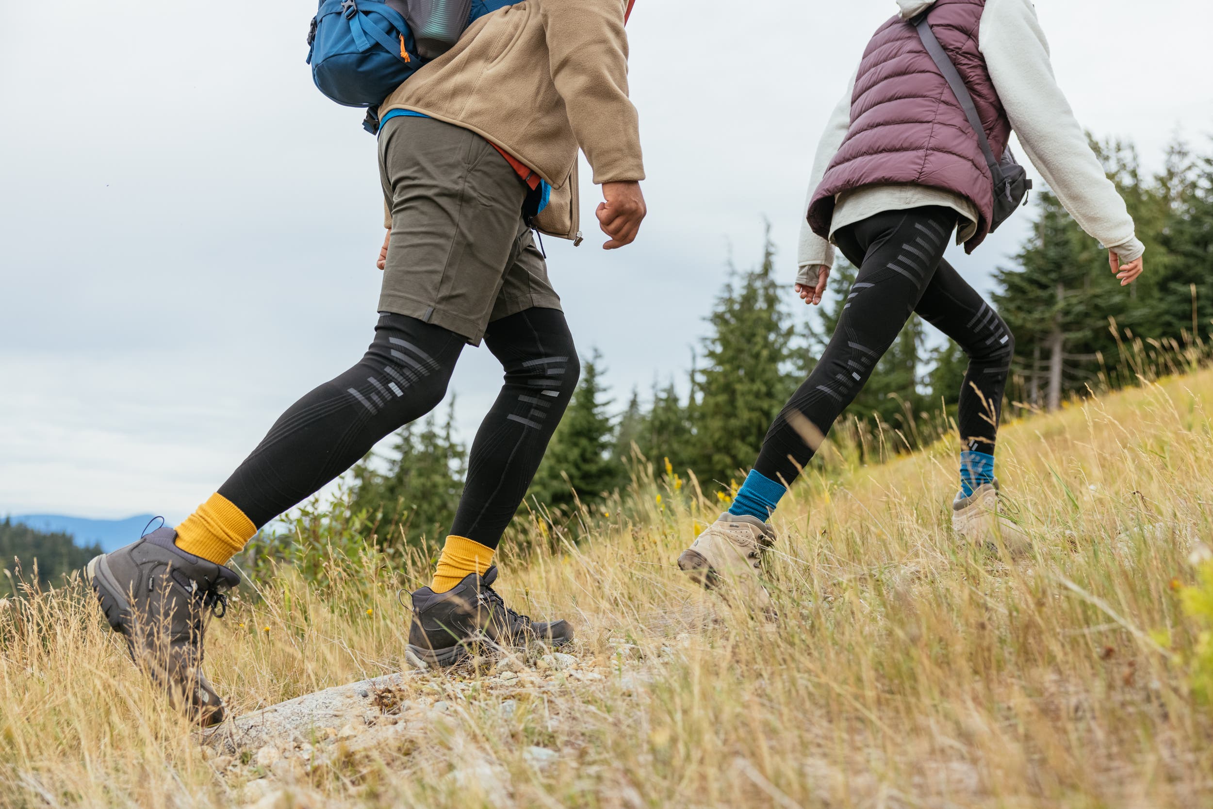 Hikers ascend a trail while wearing Stoko tights for knee protection