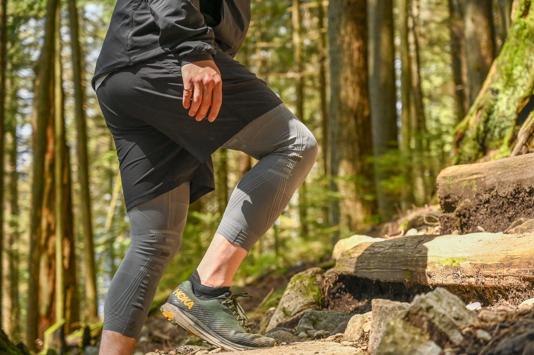 A hiker ascends a trail while wearing Stoko tights for knee protection