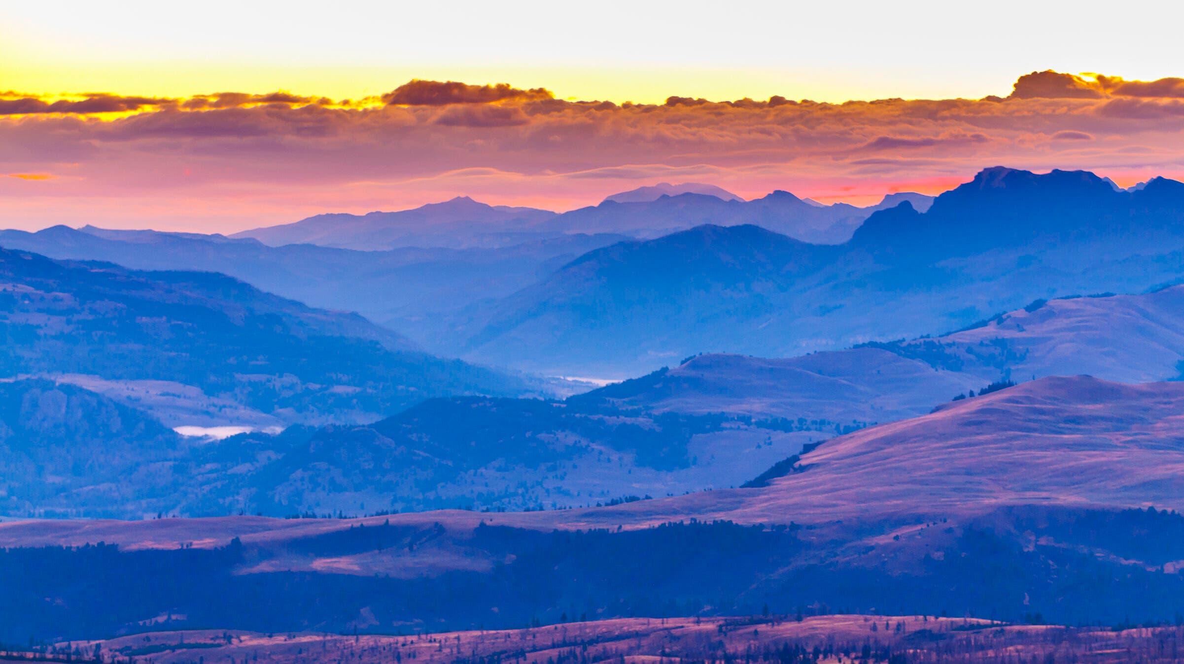 Mount Washburn, Best Sunset Hike Pastel yellows, pinks, blues, and purples fill the sky at the terminus of this sunrise hike on Mount Washburn.