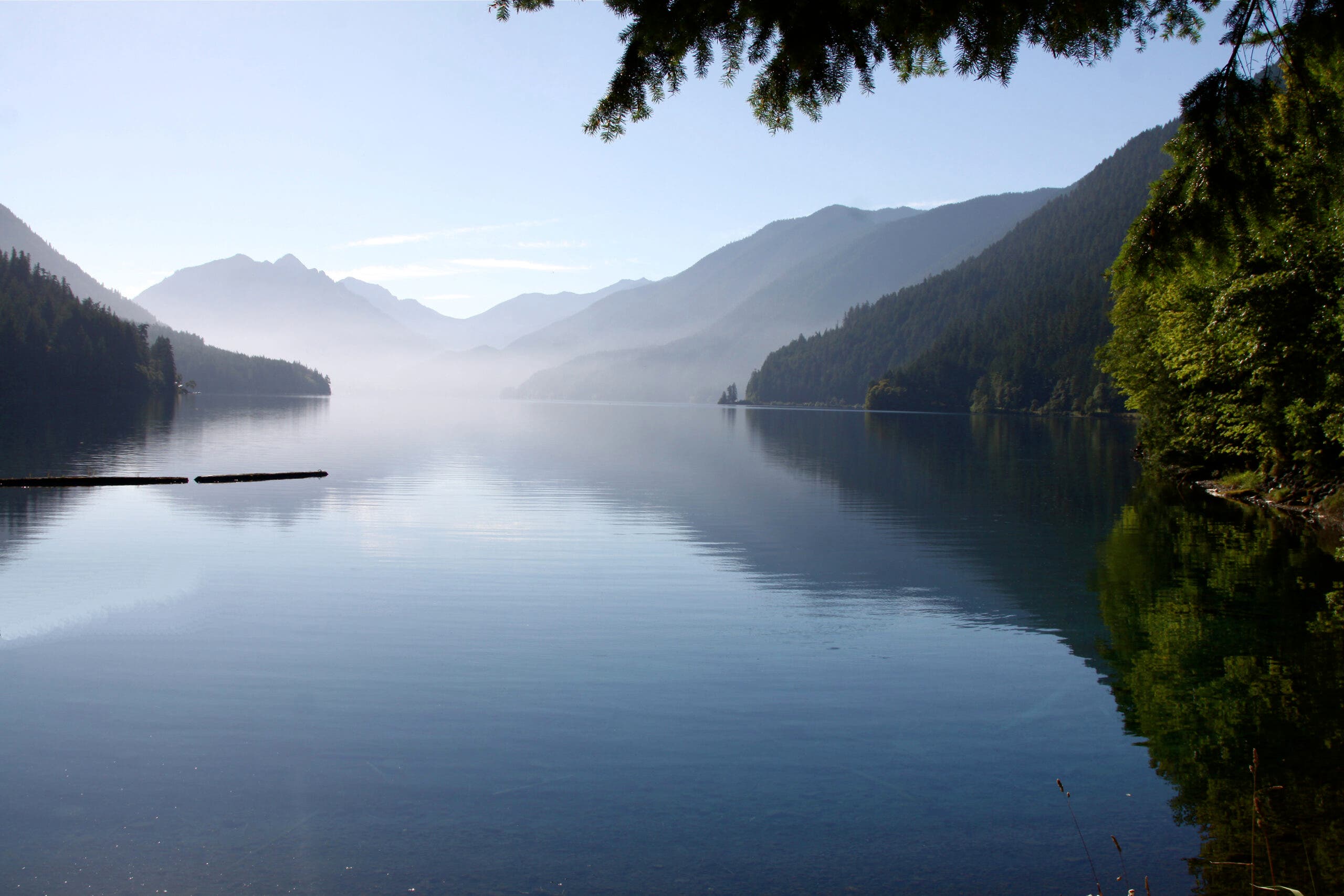 Lake Crescent with fog above the water and mountains behind