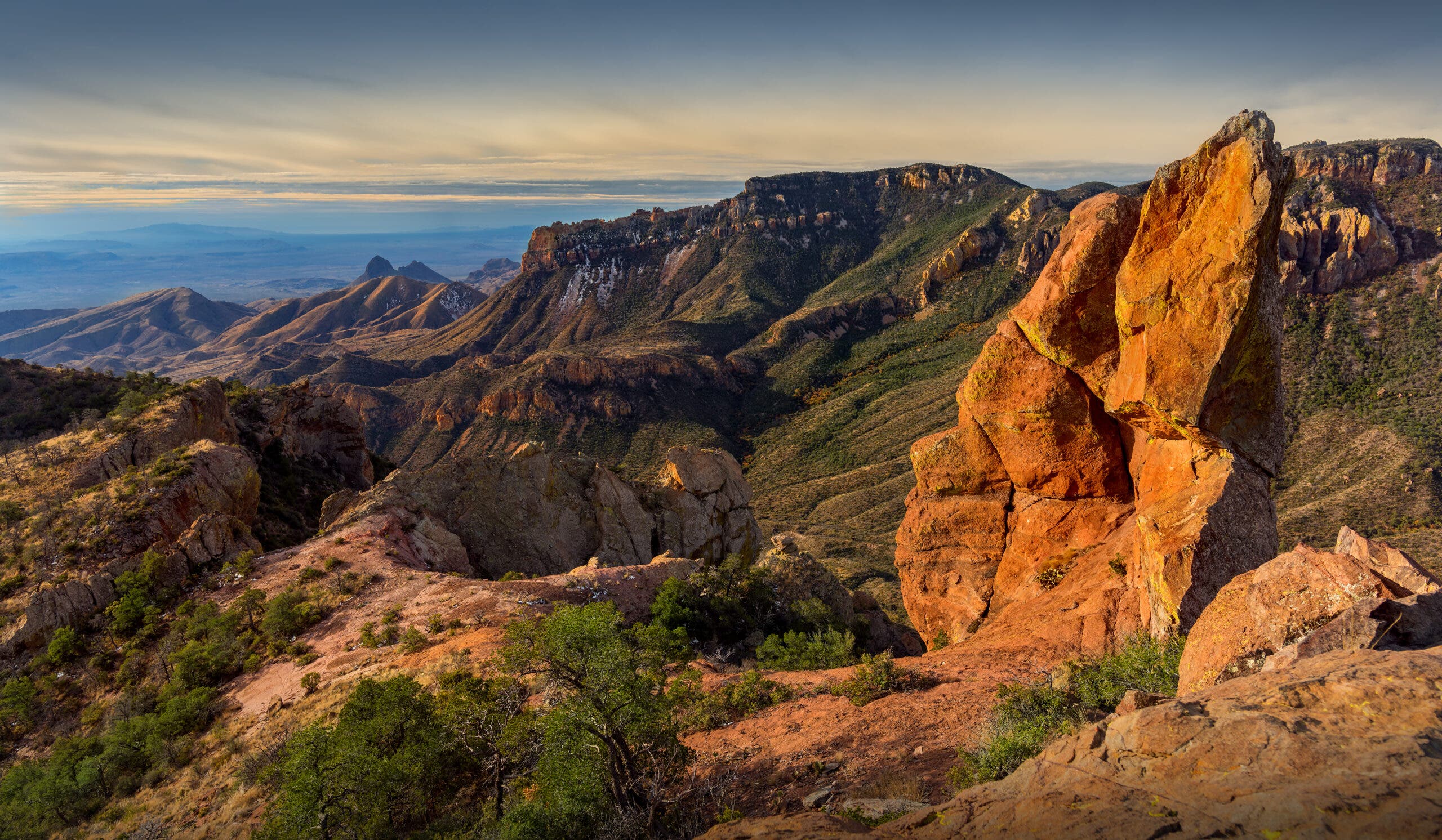 early light on the Chisos Mountains from a cliff edge