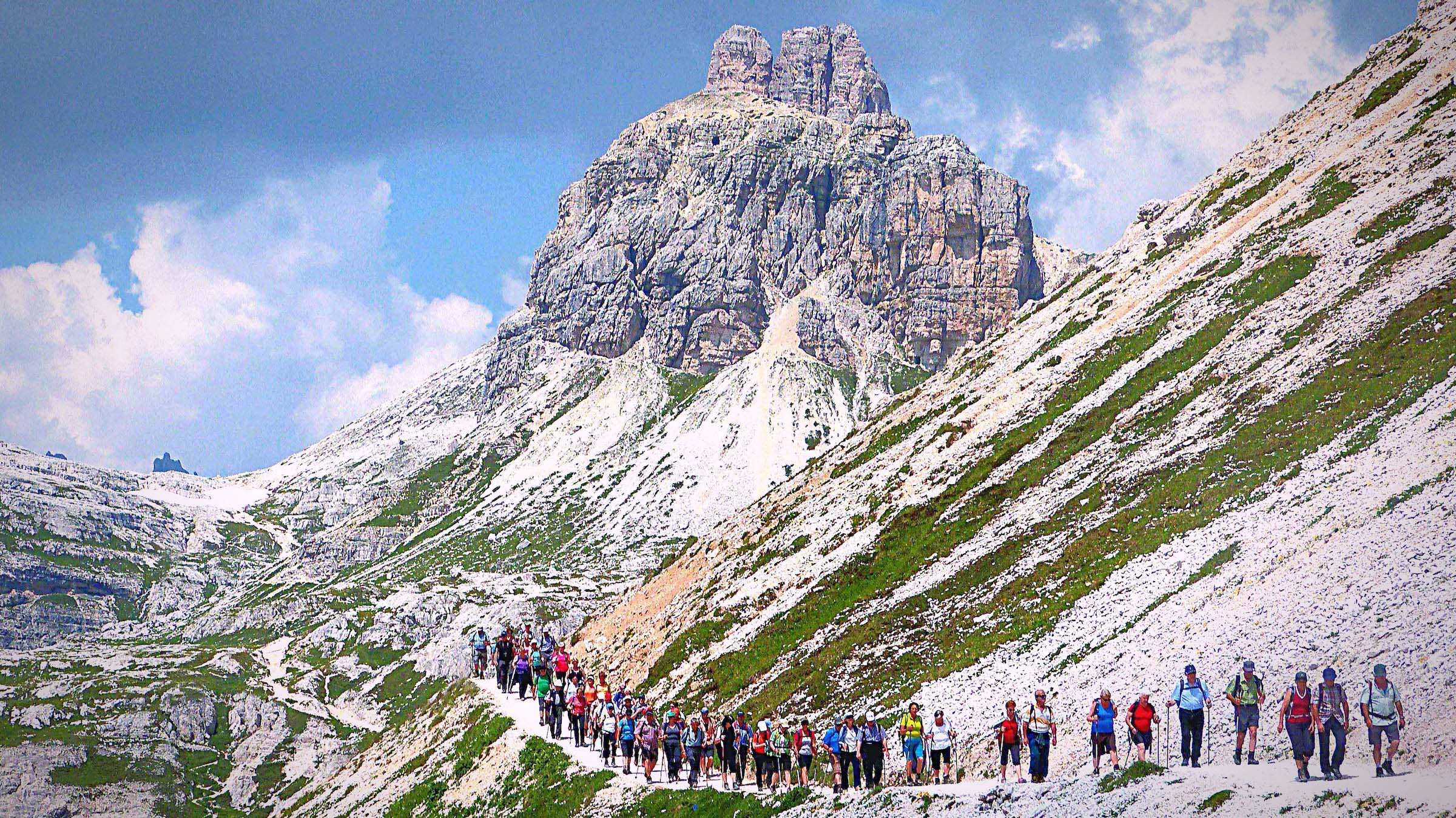 Low Angle View Of Tourists Hiking On Mountain Path