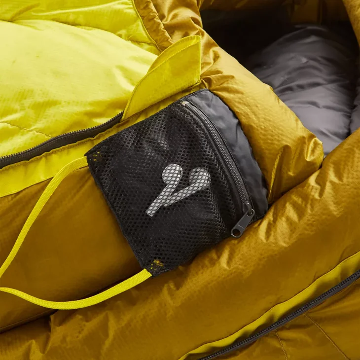 A pair of earbuds inside a sleeping bag