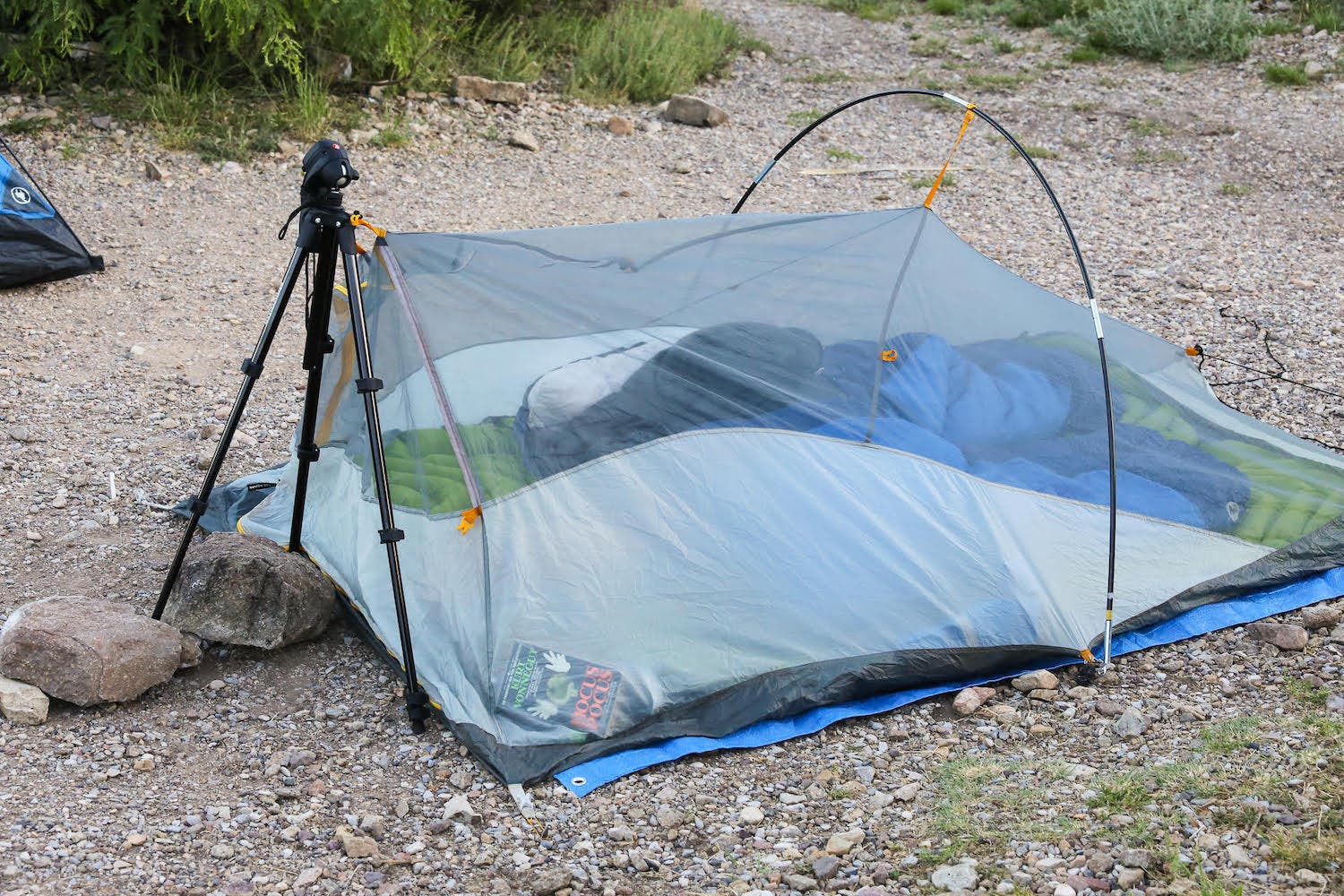image depicting tent propped up with tripod