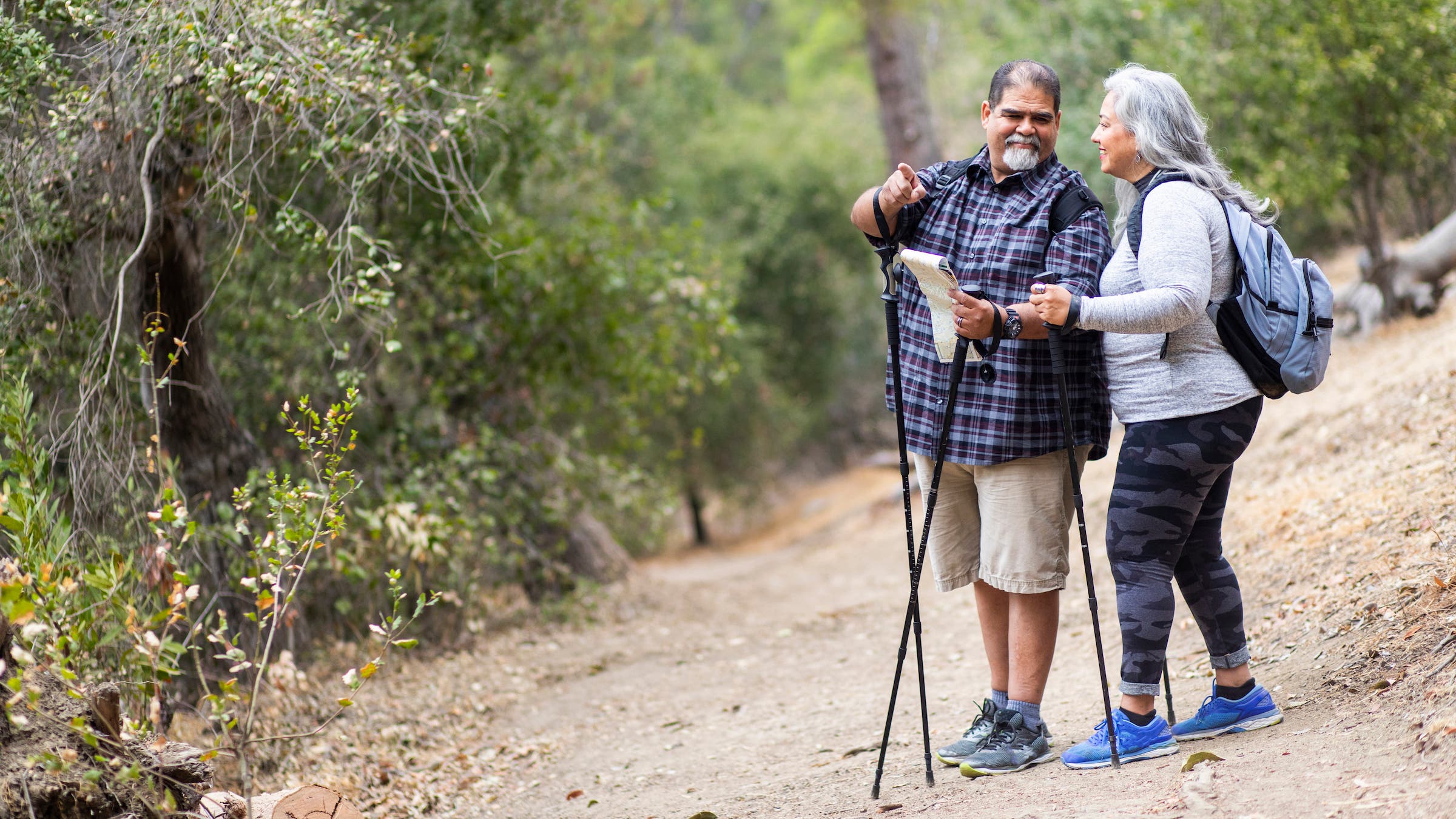 hiking couple uses trekking poles
