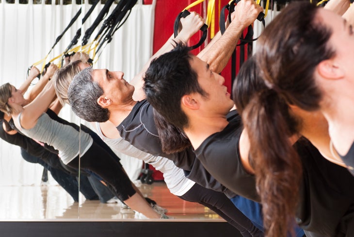 People exercising with TRX straps
