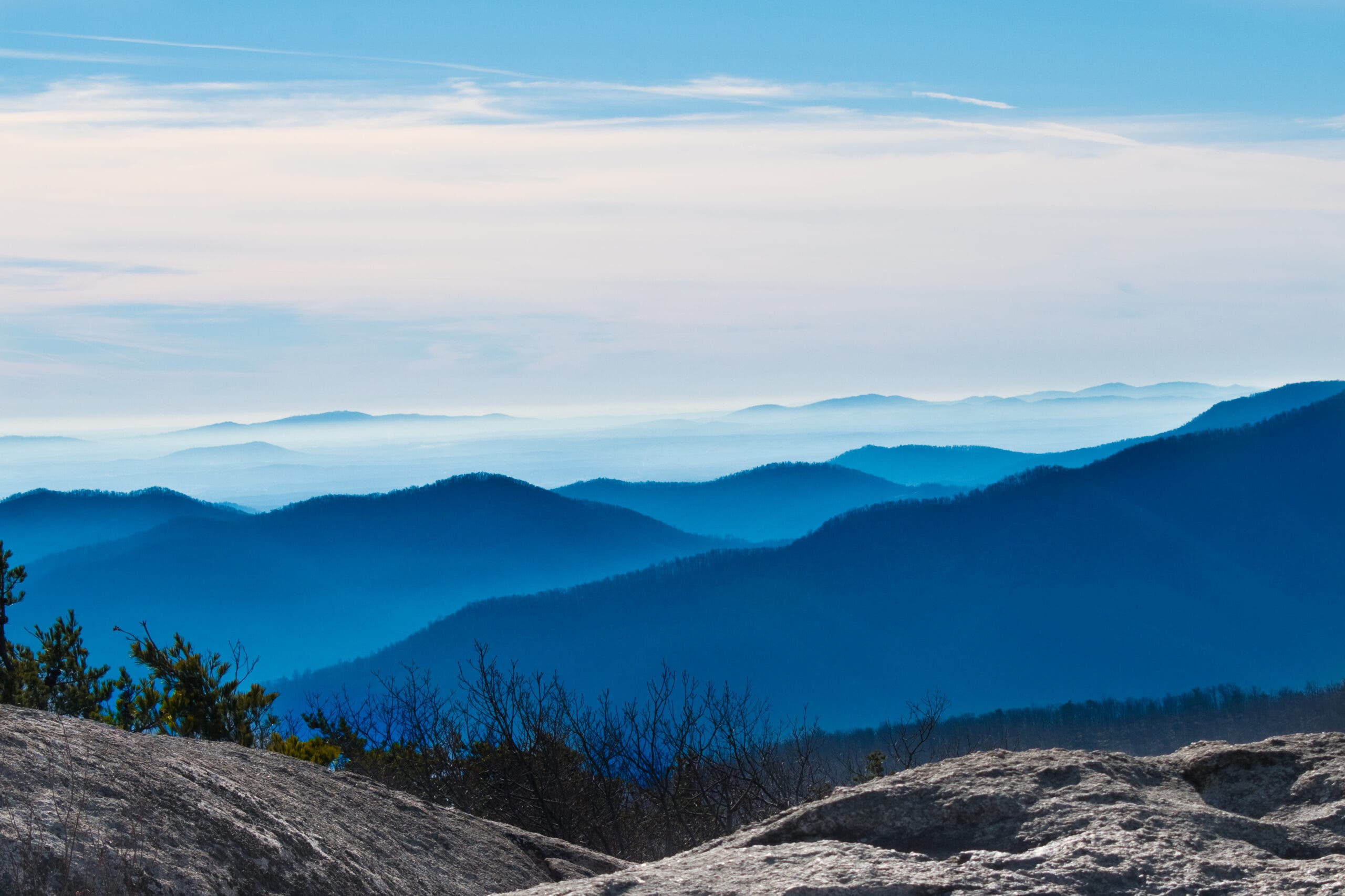 looking out from the summit of Old Rag Mountain on the ridges of the Blue Ridge Mountains fading into clouds in the distance