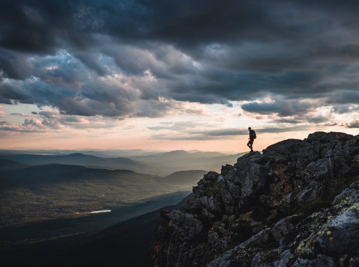 Lone hiker on mountain summit