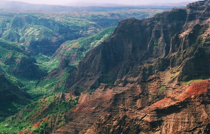 A view of the cliffs and tropical montane vegetation of the Waimea Canyon, located on the western side of Kauai, Hawaii. 