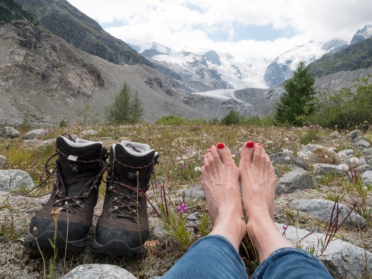 Bare foot of western tourist after trekking with hiking boots in