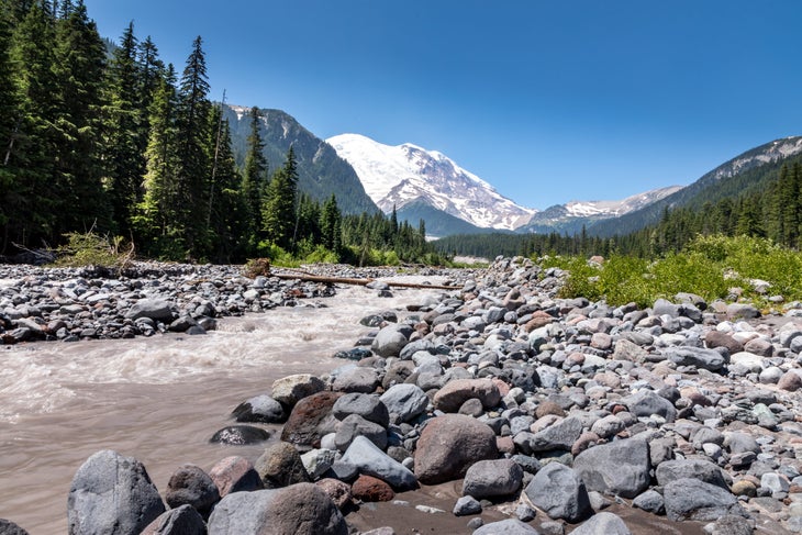 wonderland trail The peak of Mount Rainier in the Mount Rainier National Park behind the Ohanapecosh River, Washington