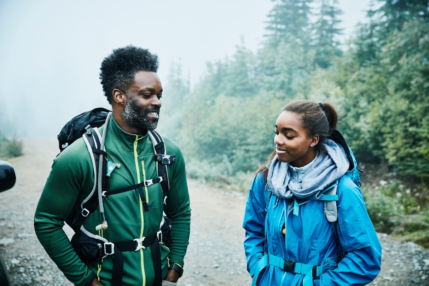 father and daughter at trailhead starting a hike