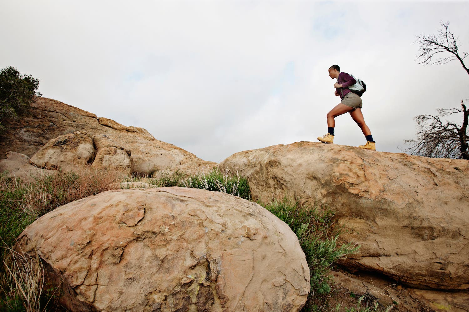 Black woman hiking on rocks