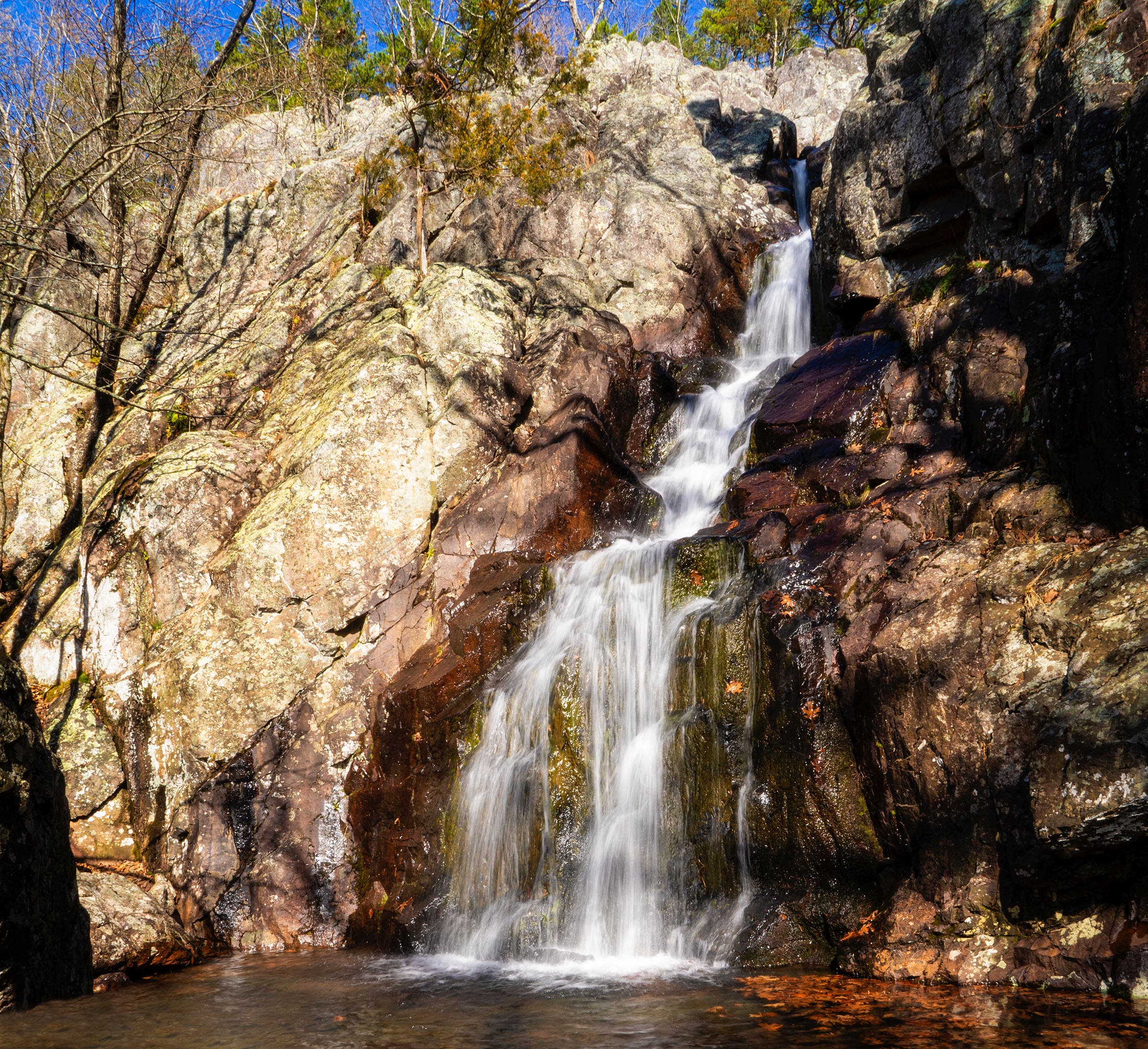 Mina Sauk Falls, Taum Sauk State Park, Ozark Mountains Mina Sauk Falls cascades down a rocky cliff face into the water below just off the Ozark Trail.