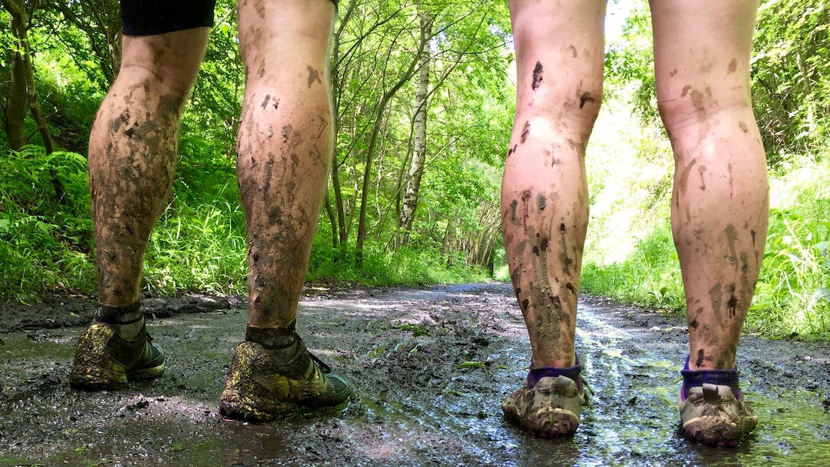 Low Section View Of Couple With Dirty Legs In Forest