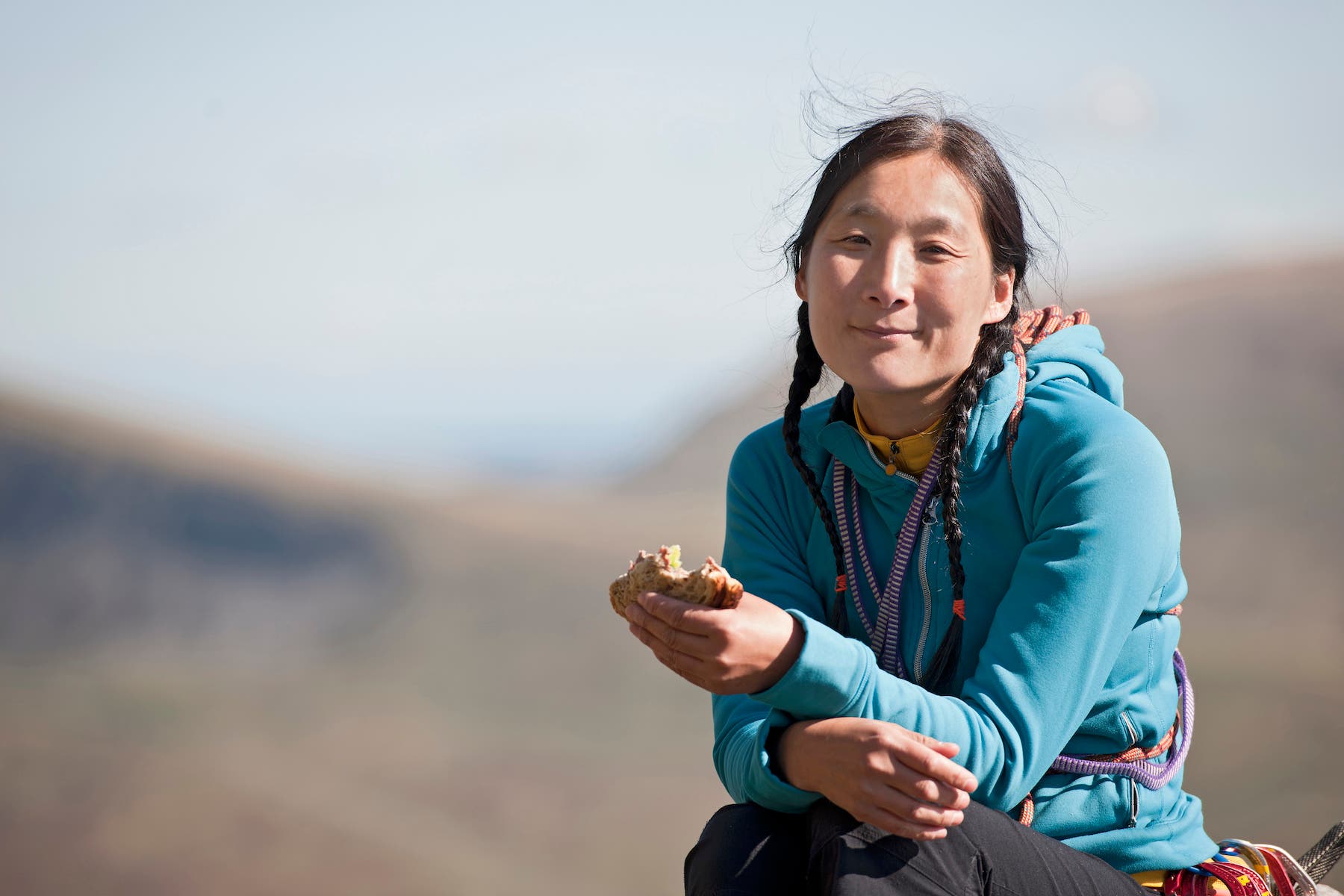 woman eating sandwich outdoors