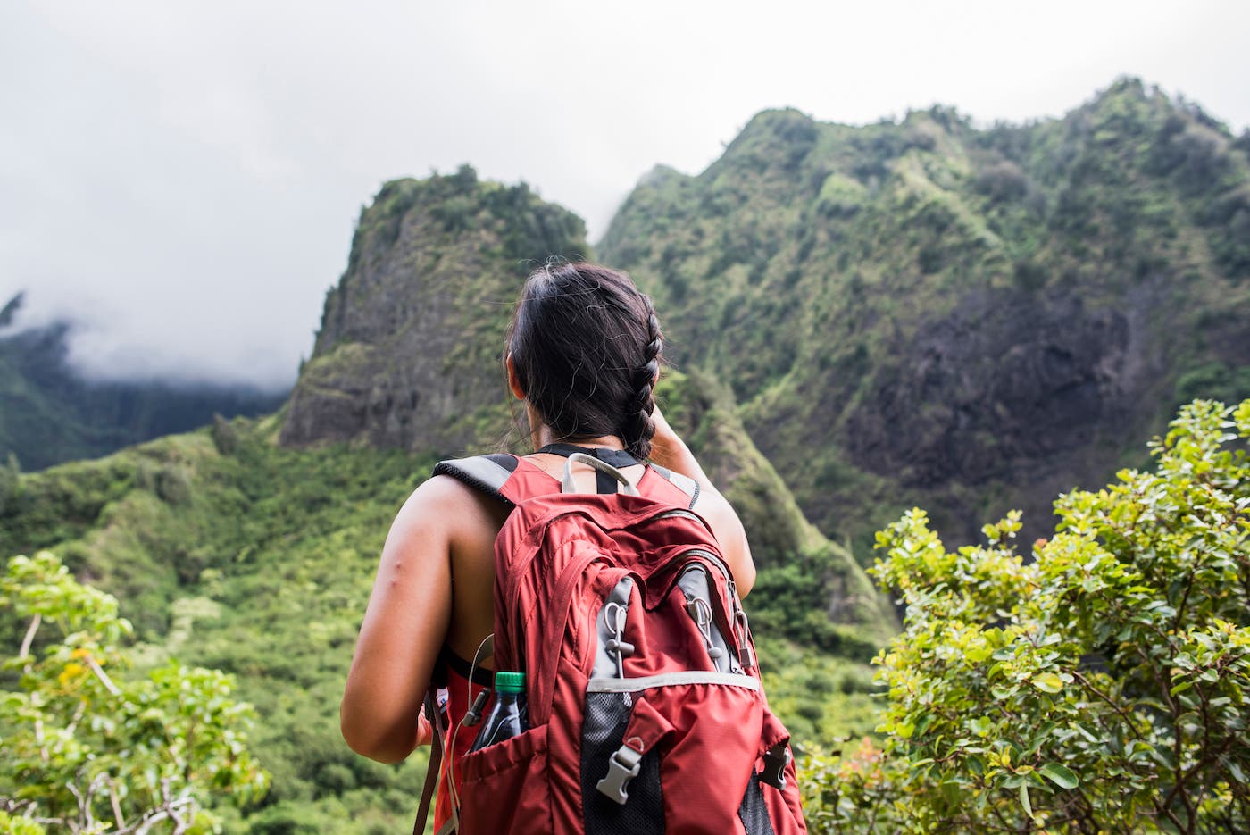 Hiker stopping to enjoy rainforest, Iao Valley, Maui, Hawaii